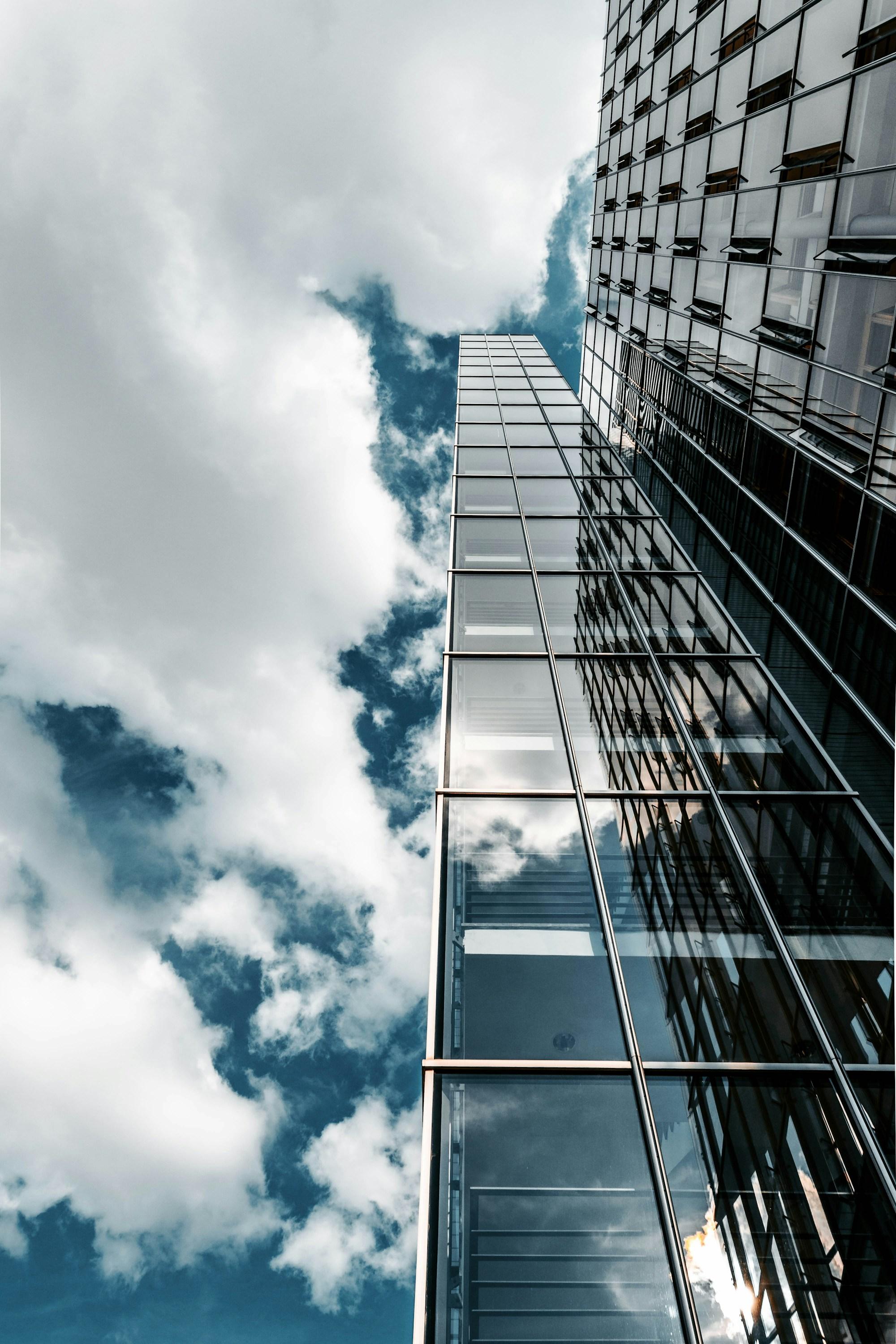 Reflective glass office towers viewed from below